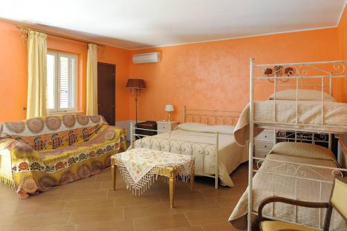 a bedroom with two bunk beds and a couch at Villa Rosa in Porto Empedocle