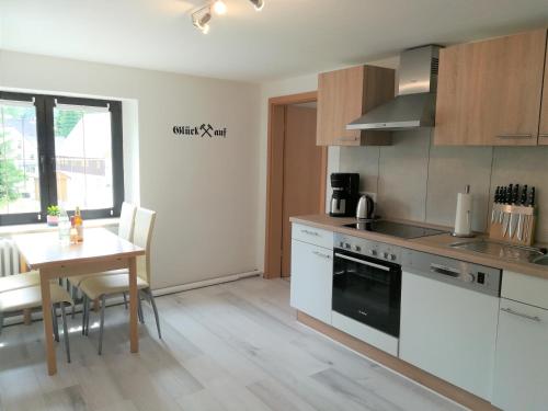 a kitchen with a table and a stove top oven at Ferienwohnung Jump INN in Kurort Oberwiesenthal