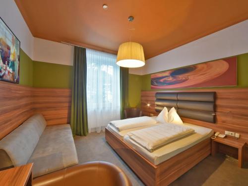 Tempat tidur dalam kamar di Hotel Ertl & mexican cantina salud