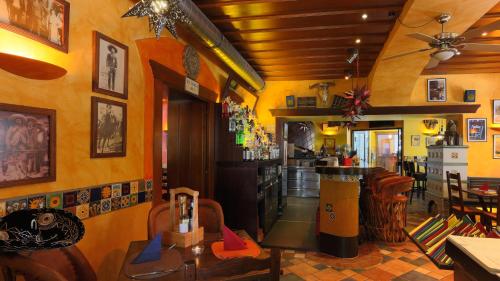 a restaurant with a bar with yellow walls at Hotel Ertl & Restaurant EL Venado in Spittal an der Drau