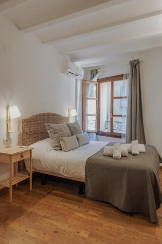 a bedroom with a large bed and a desk at Apartamentos Destino Alquézar in Alquézar