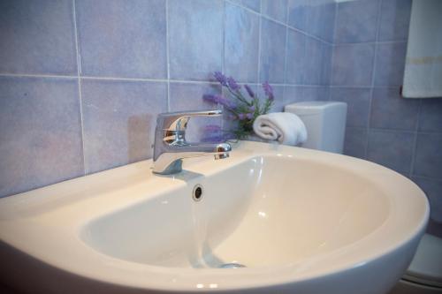 a sink with a faucet in a bathroom at Ville del Mar in San Teodoro