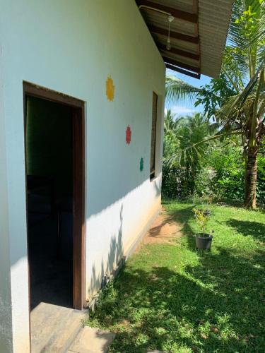 a house with a door open to a yard at Serendipity (Weligama) in Weligama