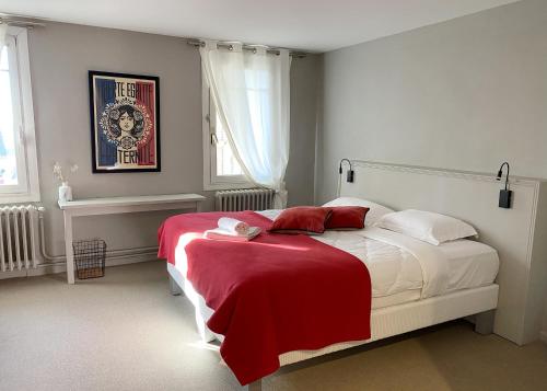 ein Schlafzimmer mit einem Bett mit einer roten Decke darauf in der Unterkunft Hôtel Paul in Aix-en-Provence