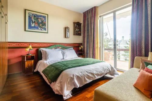 a bedroom with a bed and a window at Elena's Athenian Penthouse in Athens