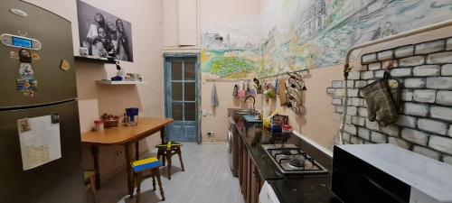 a kitchen with a stove and a counter top at Dja Hostel in Kyiv