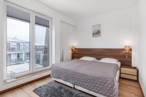 En eller flere senge i et værelse på Aquamarina Świnoujście Marina Invest