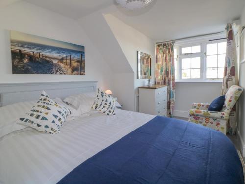 a bedroom with a blue and white bed with pillows at 46 Crowthers Hill in Dartmouth