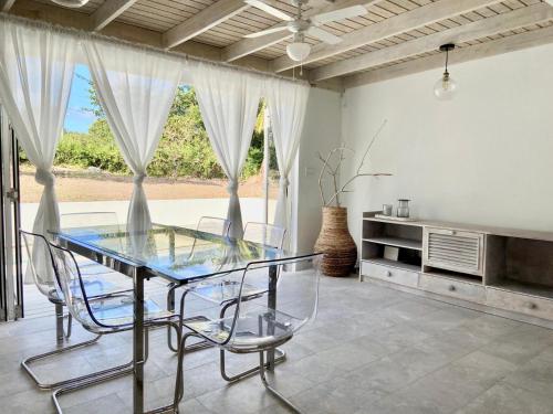 a dining room with a glass table and chairs at Modern 3Bed House in the heart of Swetes village in All Saints