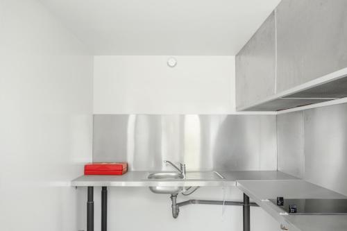 a kitchen with a sink and a counter top at Premiere Classe Thionville - Yutz in Basse-Yutz