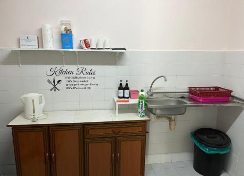 a kitchen with a sink and a counter with a sink at AF Family Guesthouse in Port Dickson