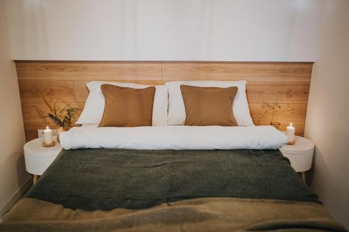 a bedroom with a large bed with two night stands at Apartamenty Boszkowo Lake Harbor in Boszkowo