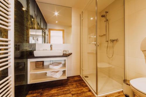 a bathroom with a sink and a shower at Weingut Kollerhof am Eichberg in Leutschach