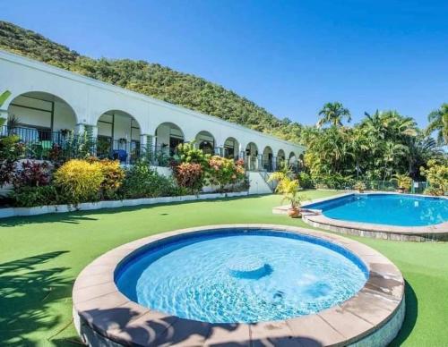 a resort with two swimming pools in a yard at Harmony Haven in Nelly Bay