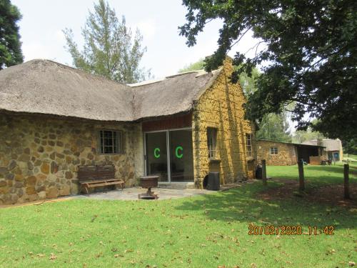 an old stone building with a grass roof at Elandskloof Trout Farm in Dullstroom