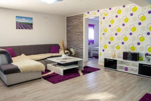 a living room with a couch and a table at Apartment in Rakovica with Wi-Fi (601-3) in Rakovica
