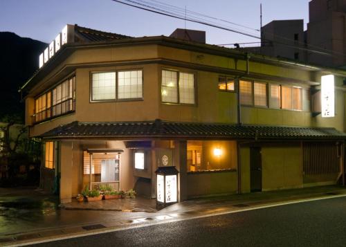a building on a city street at night at Izumi-so in Gero