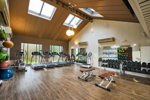 a gym with several treadmills and machines in a room at Peebles Hydro in Peebles