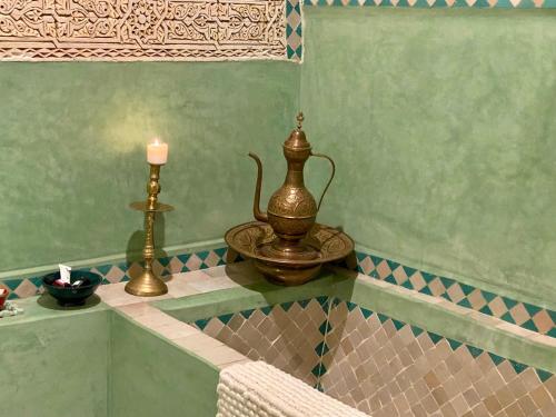 um quarto com uma vela e uma mesa com uma cadeira em Riad Hotel Sherazade em Marraquexe