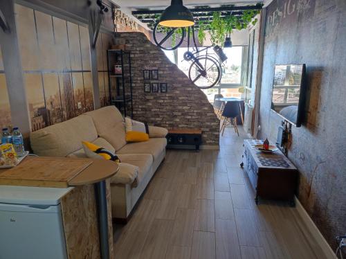 salon z kanapą i stołem w obiekcie Saltillo Alto Gray Studio. Vistas al mar y piscina w mieście Torremolinos
