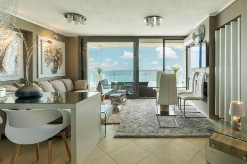 a living room with a view of the ocean at Oasis of the seas in Neoi Epivates