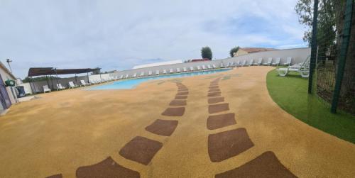 a large courtyard with chairs and a building at Camping LES PEUPLIERS in Hyères