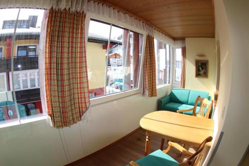 a room with a table and a chair and a window at Appartementhaus Christophorus in Obertauern