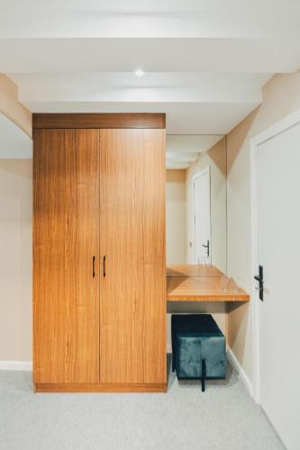 a large wooden cabinet in a room with a desk at Eleven Hotel Baku in Baku