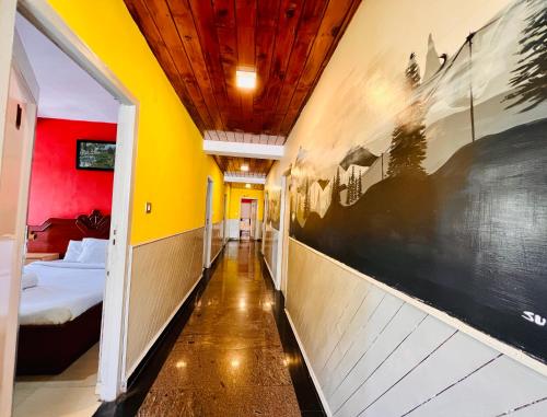 a corridor of a room with yellow and red walls at JC Woodville Manor in Kodaikānāl