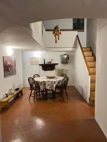 ein Esszimmer mit einem Tisch, Stühlen und einer Treppe in der Unterkunft Pasha Apartment in Florenz