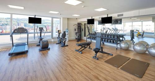 a gym with treadmills and cardio equipment in a building at NH Collection Villa de Bilbao in Bilbao