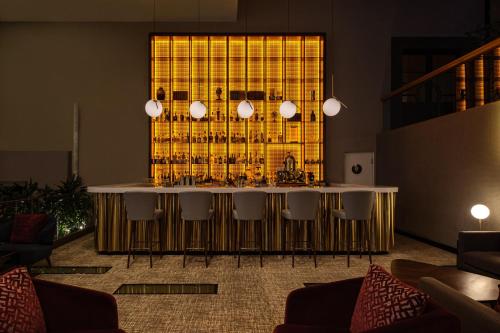 a bar in a room with a bunch of wine bottles at InterContinental Malta by IHG in St Julian's
