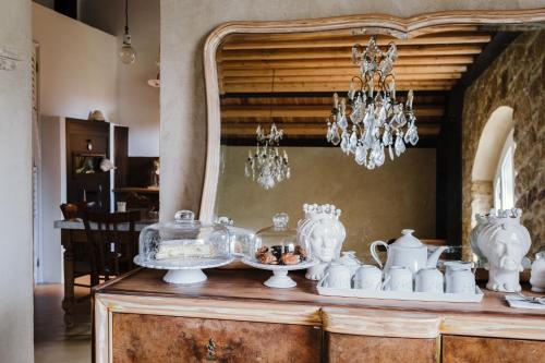 阿格里真托的住宿－La pagliera，餐桌上摆放着碗碟和吊灯