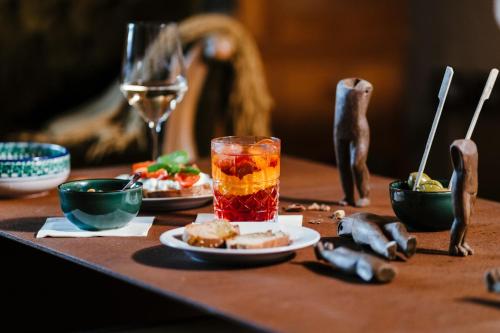 a table with a drink and a plate of food at La pagliera in Agrigento