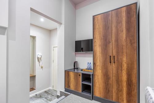 a kitchen with a white refrigerator and a wood floor at Eleven Hotel Baku in Baku