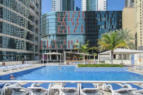 a swimming pool in the middle of a city with buildings at GuestReady - The Marina Splendor in Dubai