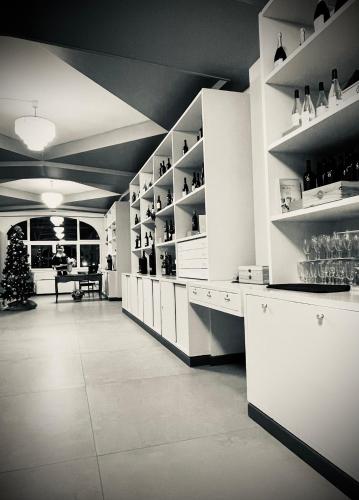 a large room with white shelves and a christmas tree at Hotel Hermitage in Poggio a Caiano