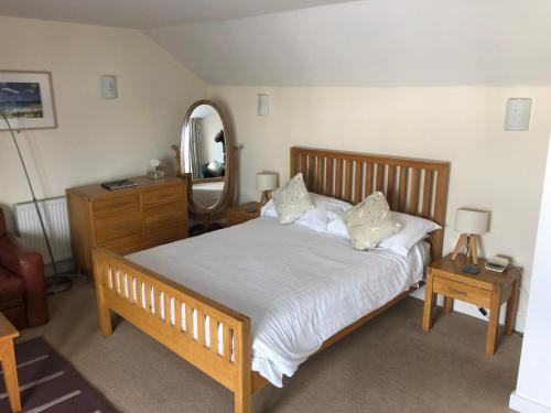 a bedroom with a large bed and a mirror at The Dolphin Tavern in Penzance