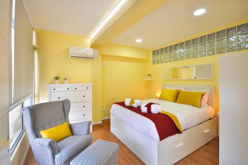 a small bedroom with a bed and a chair at RH Charming Apartment Liberdade II in Braga