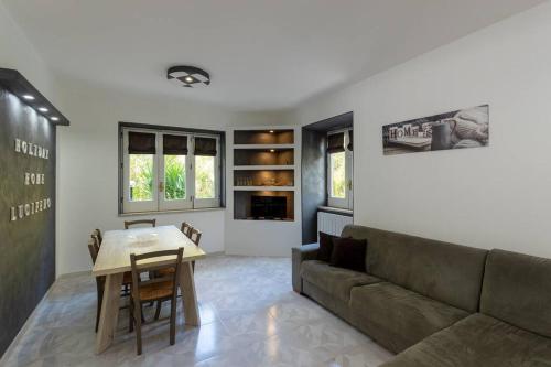 a living room with a couch and a table at Holiday Home Lucifero in Contura