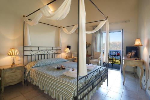 a hotel room with a large bed and a large window at Agnantia Bed & Breakfast in Fiskardo