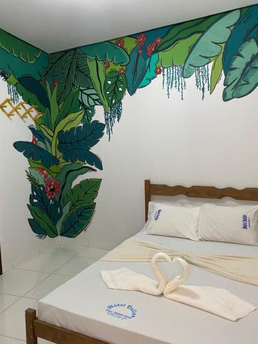 a bedroom with a bed with two swans on it at Hotel Dallas Toríbio in Bom Jesus da Lapa