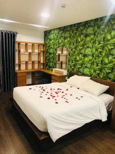 a bedroom with a bed with red roses on it at Seaside Homestay Beachfront in Vung Tau