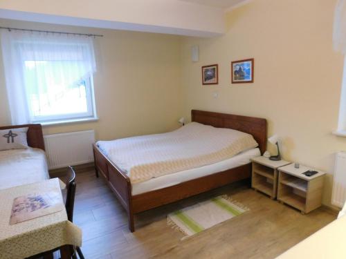 a small bedroom with a bed and a window at KAJA Zawoja in Zawoja