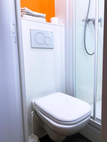 a bathroom with a toilet and a shower at Premiere Classe Arras - Tilloy Les Mofflaine in Tilloy-lès-Mofflaines