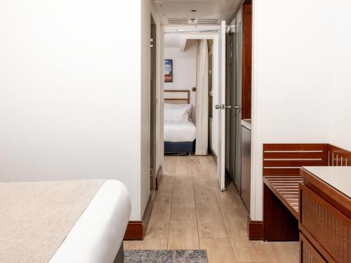 a hotel room with a bed and a bathroom at King Solomon by Isrotel Collection in Eilat