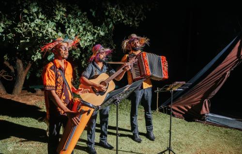 a group of musicians playing music on the grass at Lakegala Resort in Matale