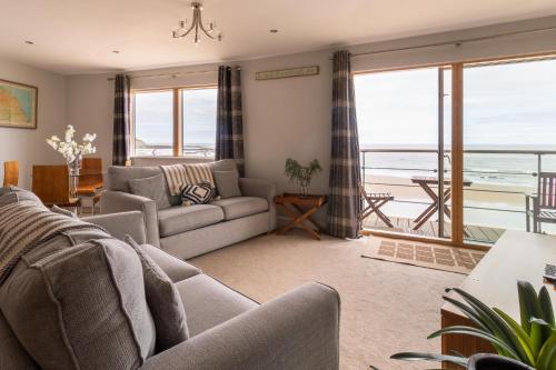 a living room with a couch and a view of the ocean at The Sands Sea Front Apartments in Scarborough