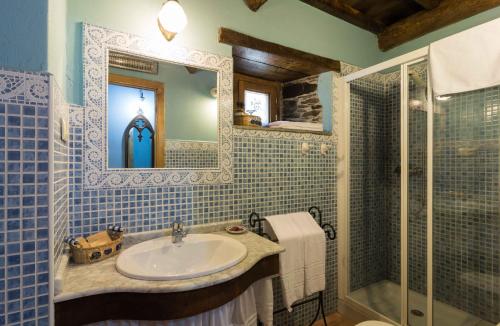 a bathroom with a sink and a shower at O Muiño de Pena in O Pino 