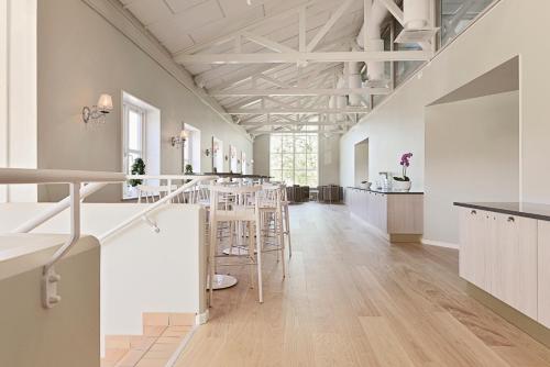 a large room with a bar with stools at Skytteholm in Ekerö